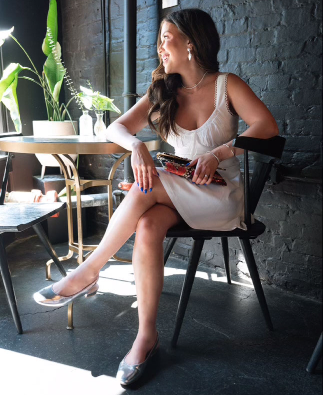 cecily bauchmann at a cafe wearing the claire slingback flat