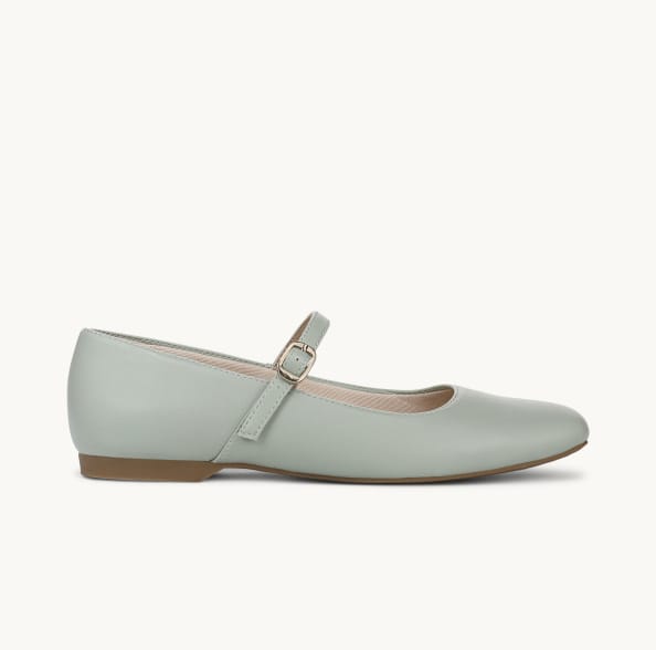 A side view of a jade green Mary Jane flat with the toe facing right.