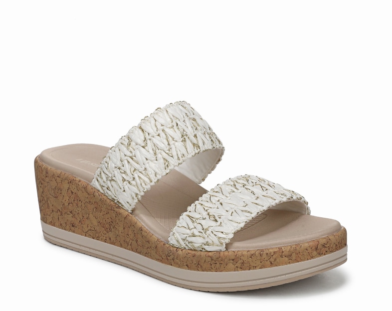 An angled view of a cork-bottom wedge sandal with white raffia straps. 