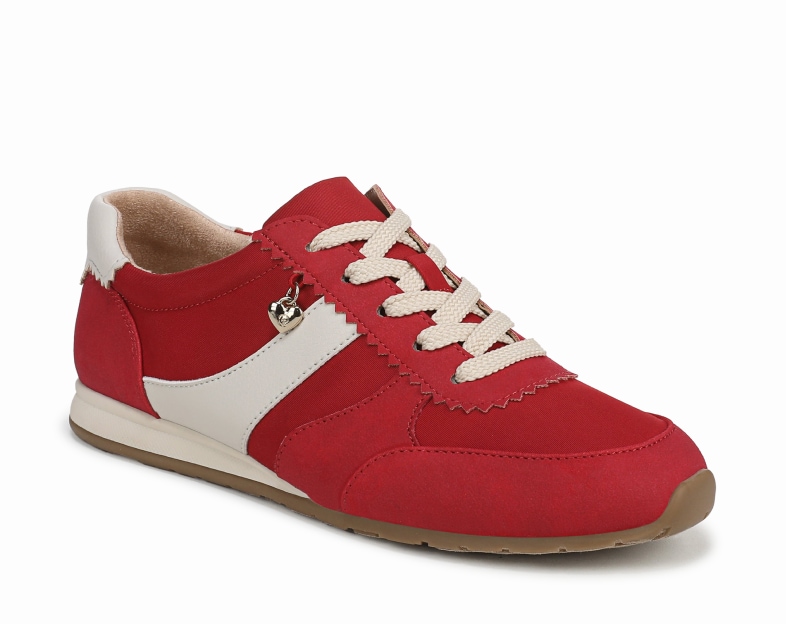 An angled view of a red women's sneaker with cream-colored stripe on the side. 