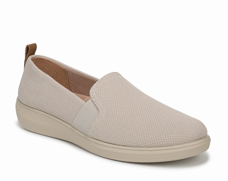 An angled view of a women's slip on shoe in a tan knit fabric. 