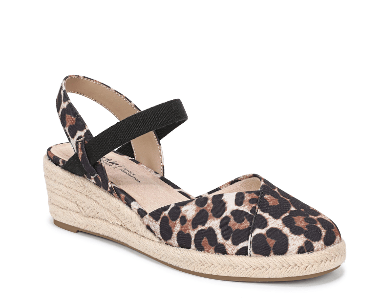 An angled view of a closed-toe espadrille with a leopard print upper. 