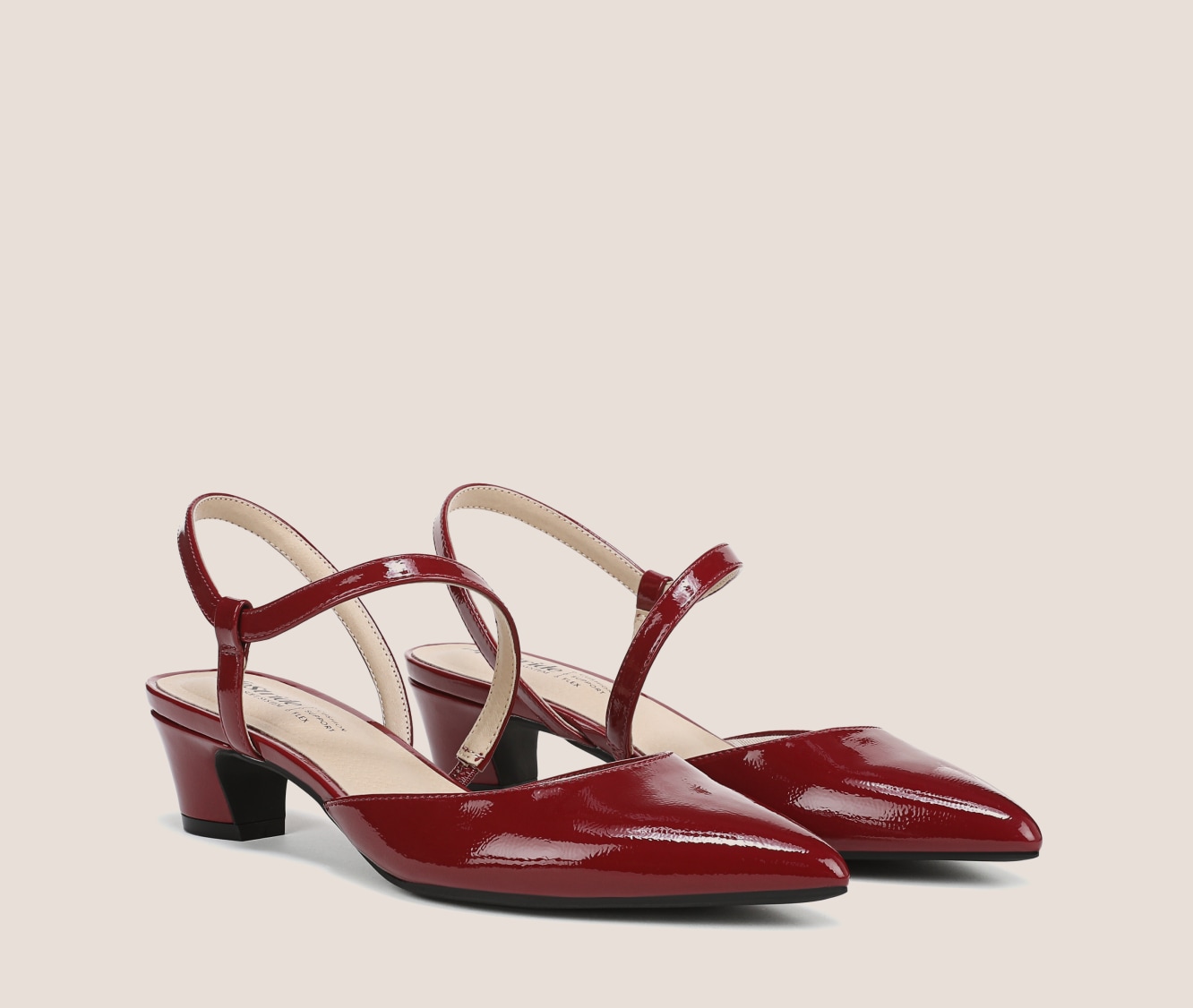 A pair of Minimalist strappy heels with a pointed toe and a low block heel in the color dark cherry red.