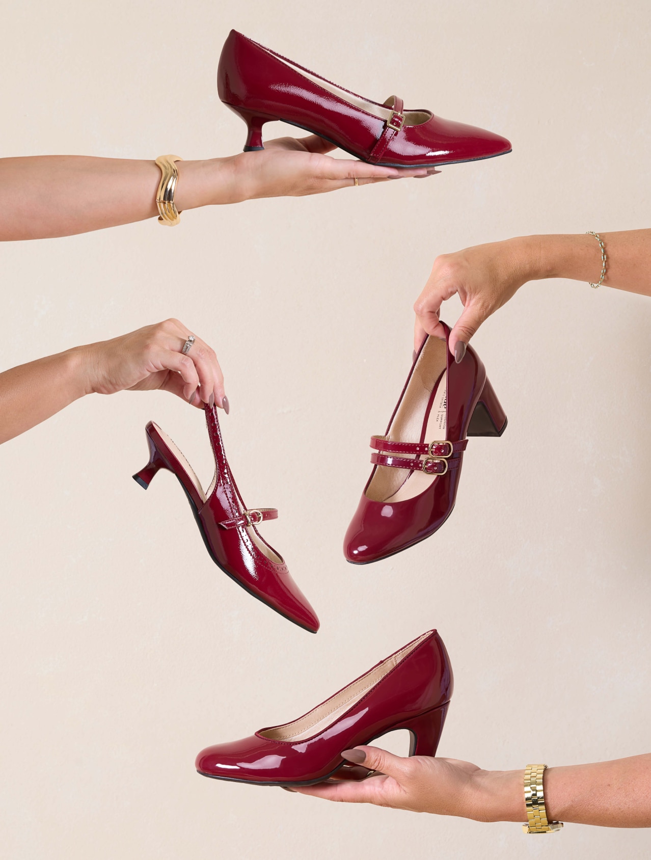Model’s hands holding a variety of LifeStride heels, slingbacks and mary jane heels for women in the dark cherry red color.