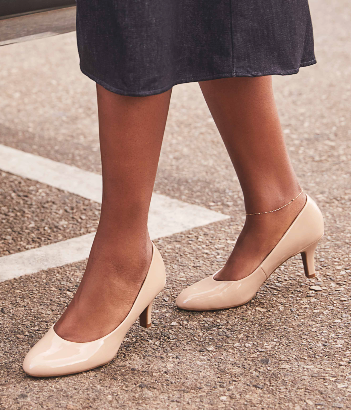 Model walking in LifeStride taupe colored heels