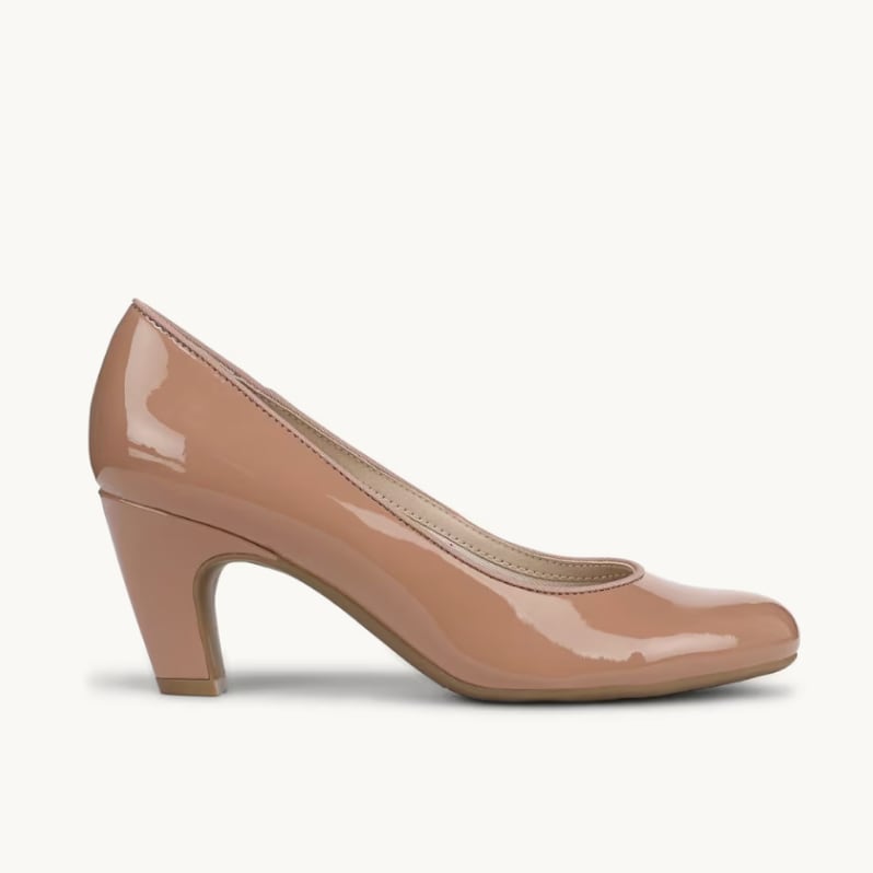A side view of a nude patent pump with the toe facing to the right.