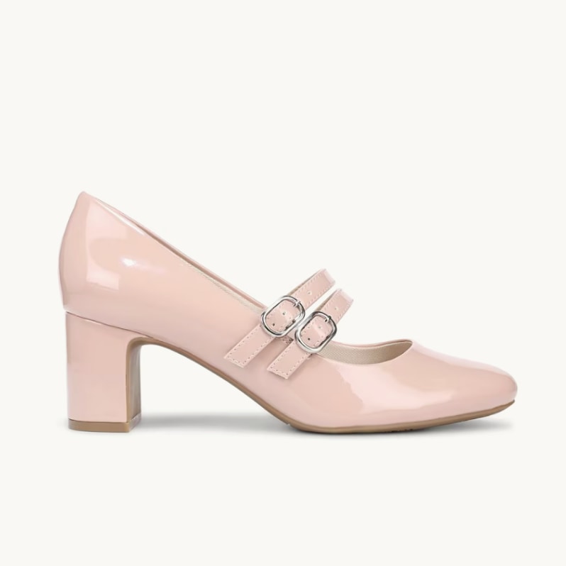 A side view of a light pink patent Mary Jane heel with the toe facing to the right. 