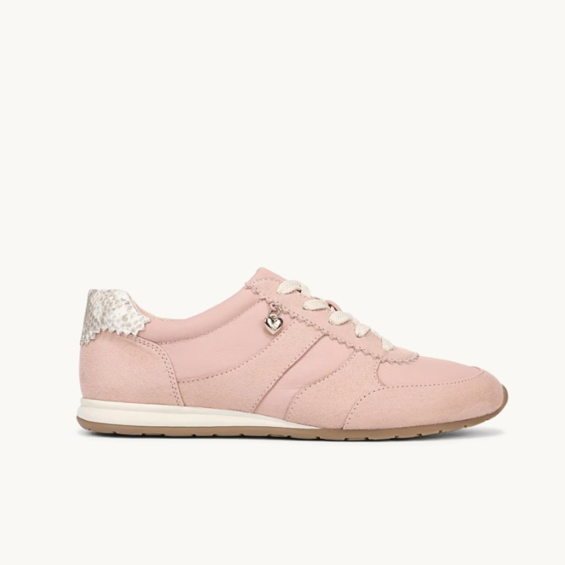 A side view of a pink sneaker with the toe facing to the right. 