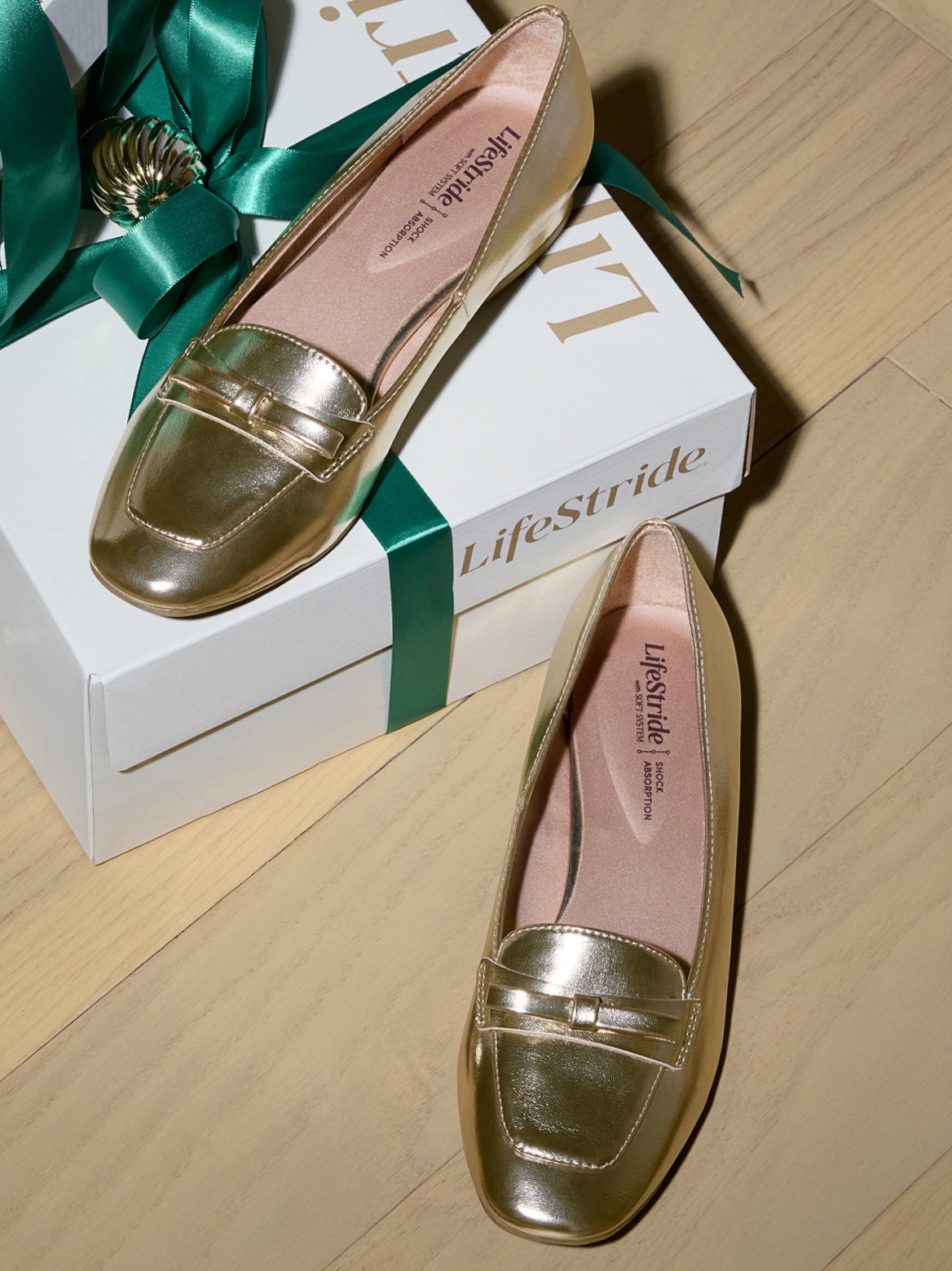 gold metallic LifeStride flats on a gift-wrapped LifeStride box