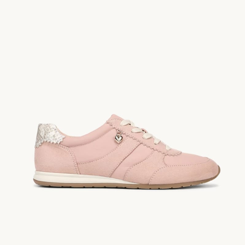 Side view of a women's pink sneaker with microsuede panels, snake print detail at the heel, and a gold heart charm. 