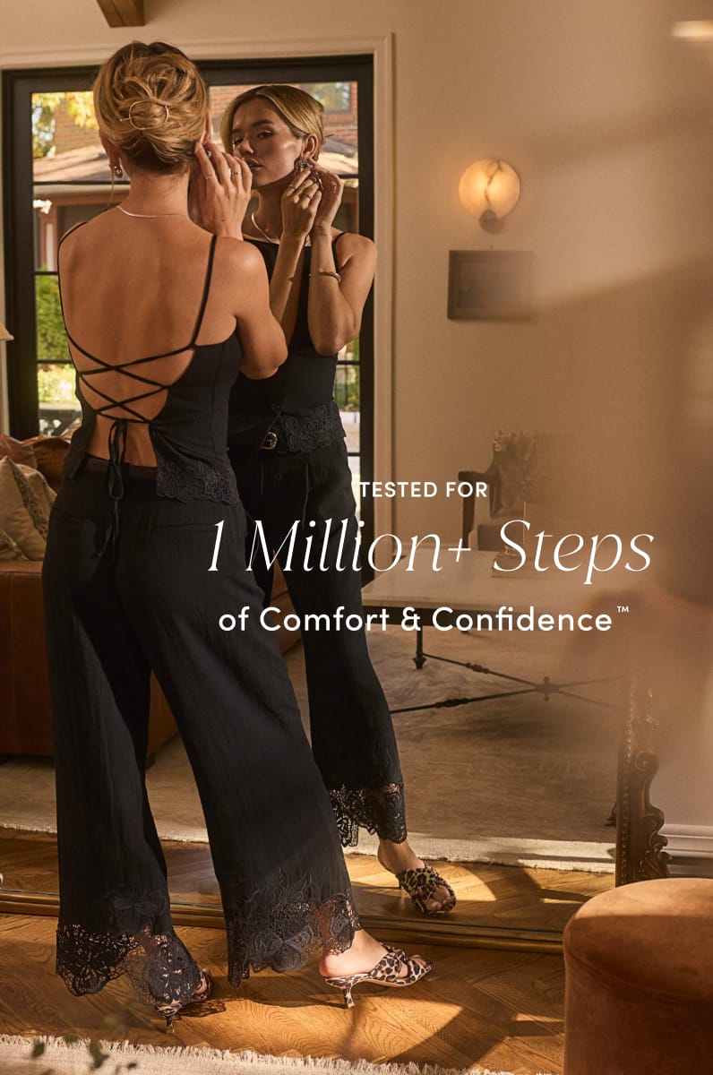 Woman wearing a black outfit and leopard-print heels adjusting her earring in a mirror, with text reading “Tested for 1 Million+ Steps of Comfort & Confidence.