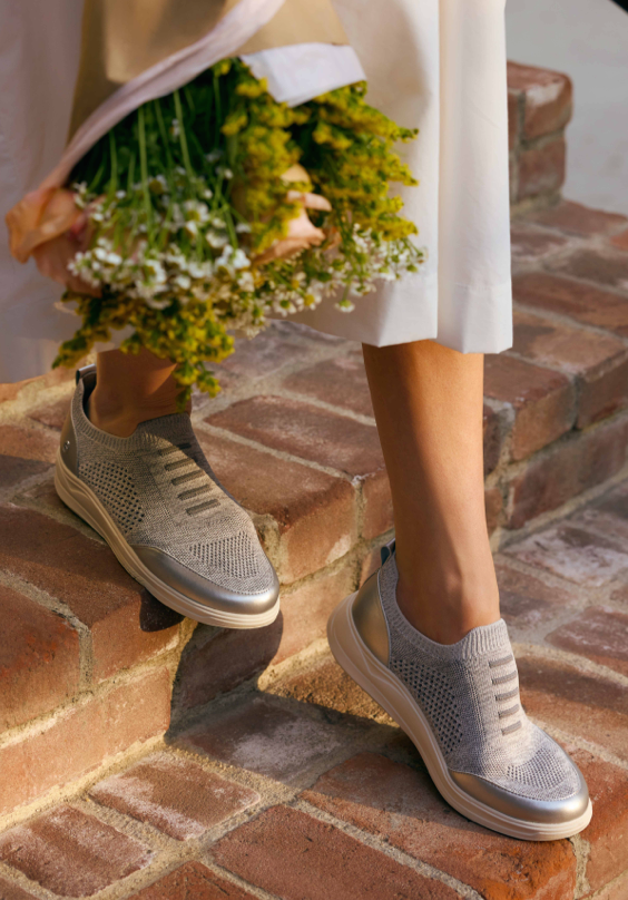 Model wearing grey fabric and silver metallic LifeStride casual shoes