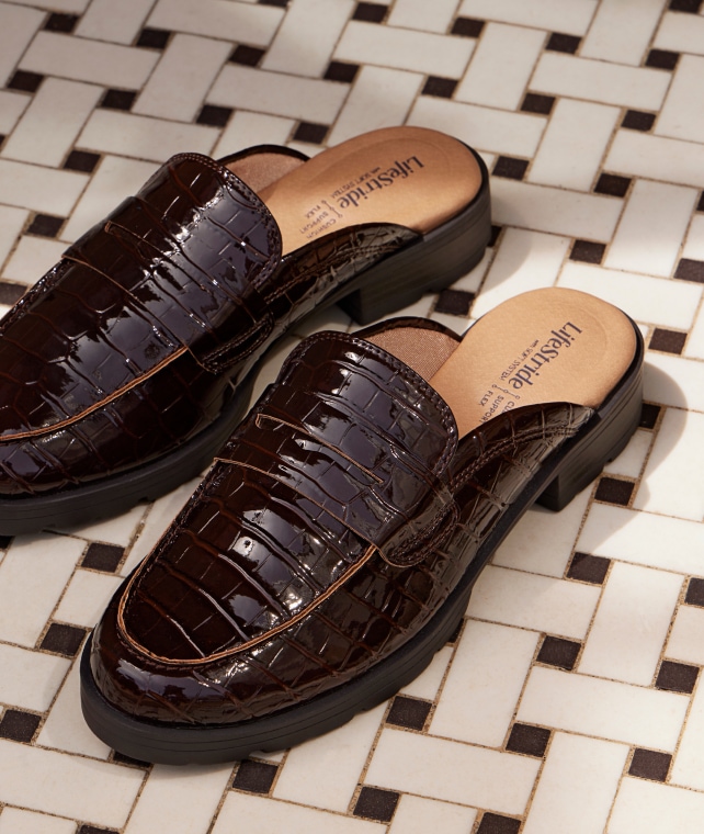 A pair of LifeStride chocolate brown shoes on a white and black floor