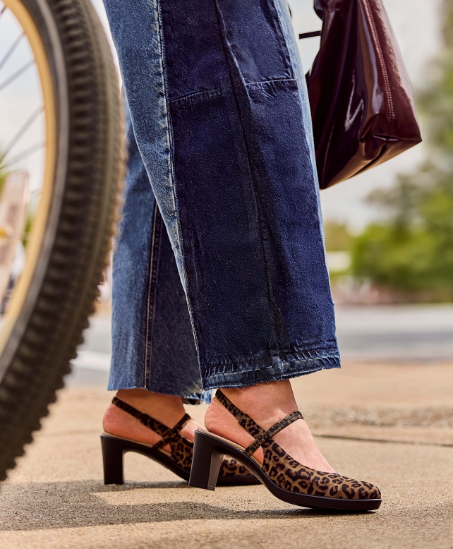 A model wearing jeans and LifeStride leopard print heels