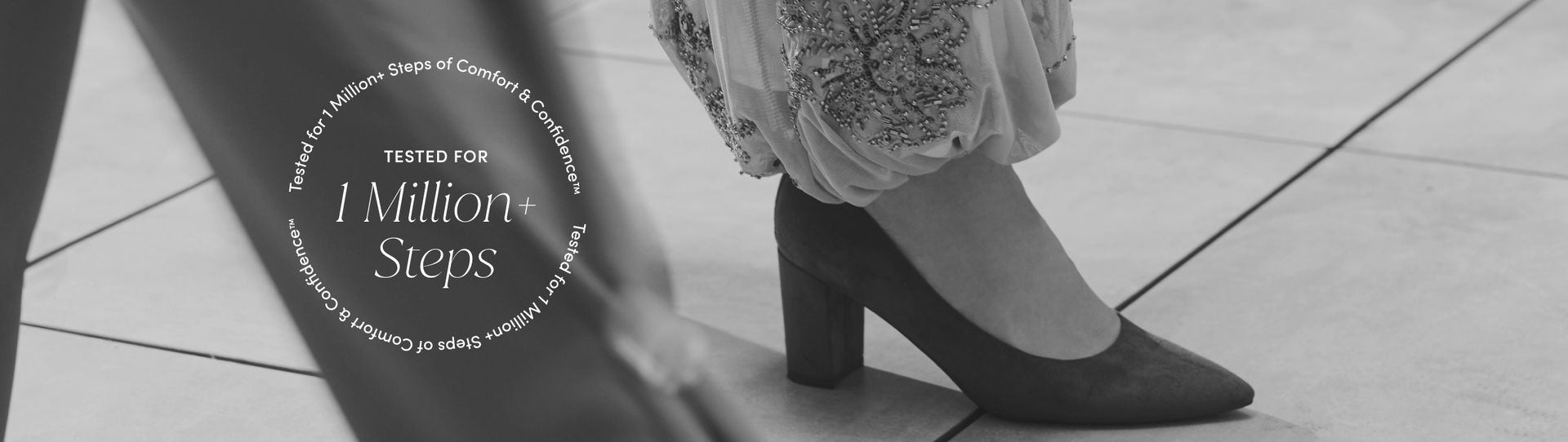 Closeup of a woman wearing a pointed toe pump. 